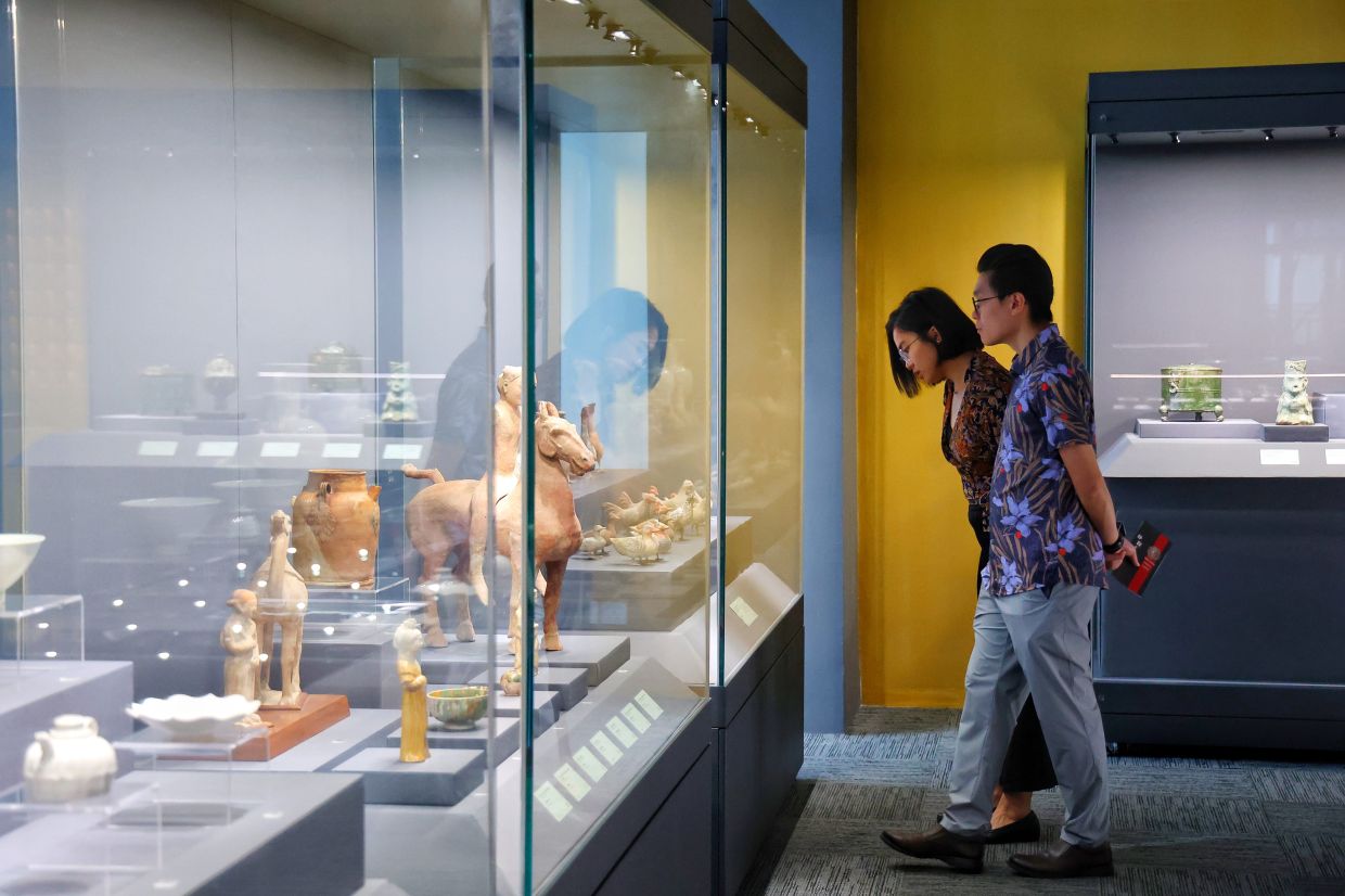 Visitors reading the exhibition notes in one of the halls at the Ken Museum. Photo: The Star/Muhamad Shahril Rosli