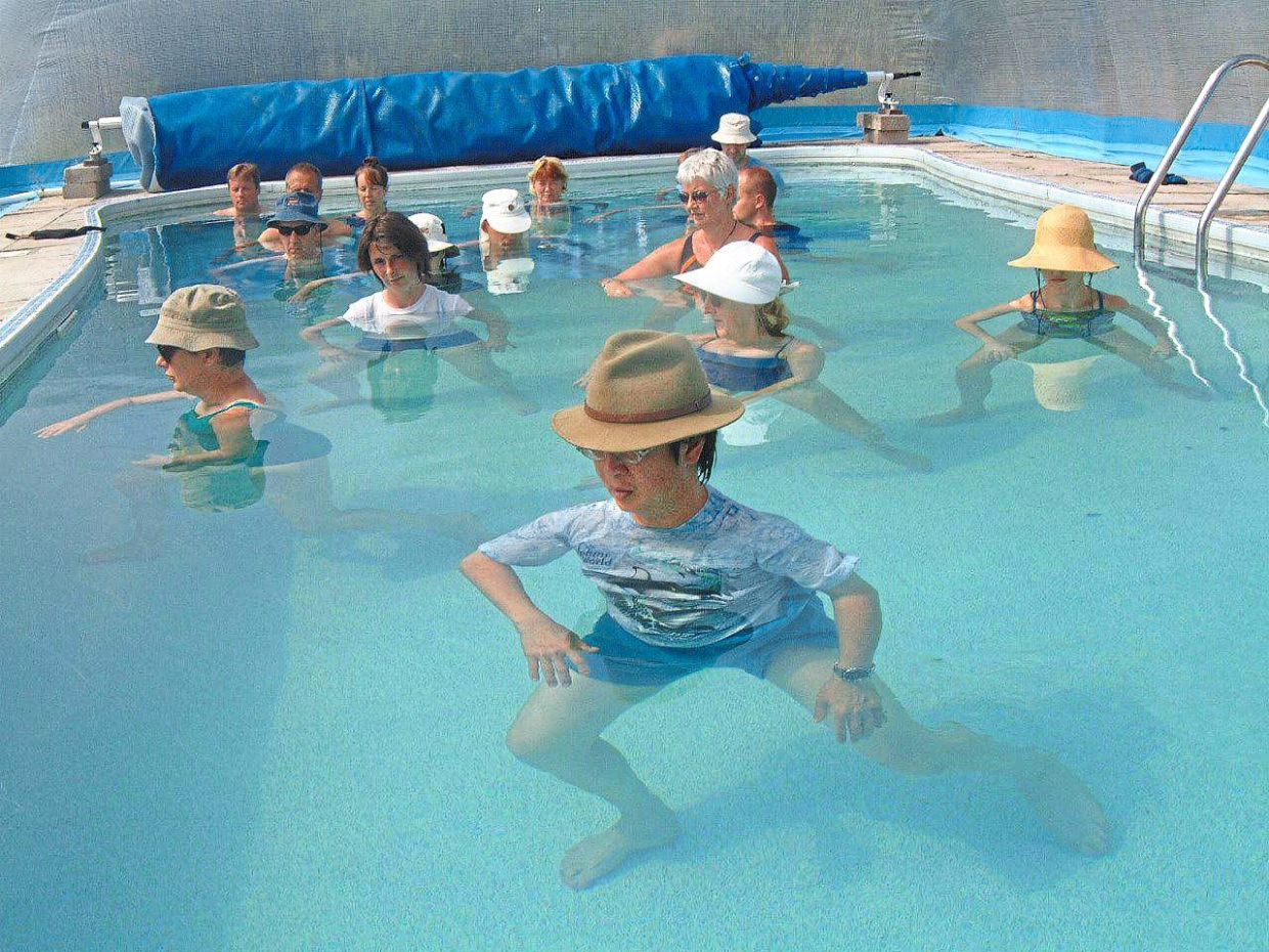 You can do a wide variety of exercises in the water, even tai chi, as seen in this class held in Devon, England. — PETER CHIN