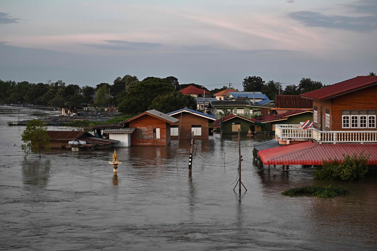 Houses are flooded along the river bank in Bang Ban district in the central Thai province of Ayutthaya on Nov 14, 2025. - AFP