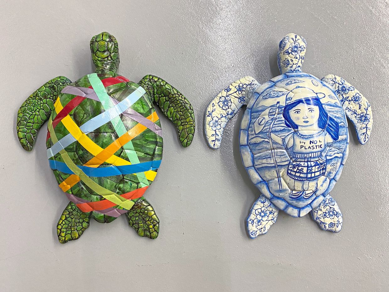 Painted turtle sculptures 'Spectrum Of Survival' by Hidayat (left) and 'Guardian Of The Blue Sea' by Amy. Photo: Hidayat Arshad 