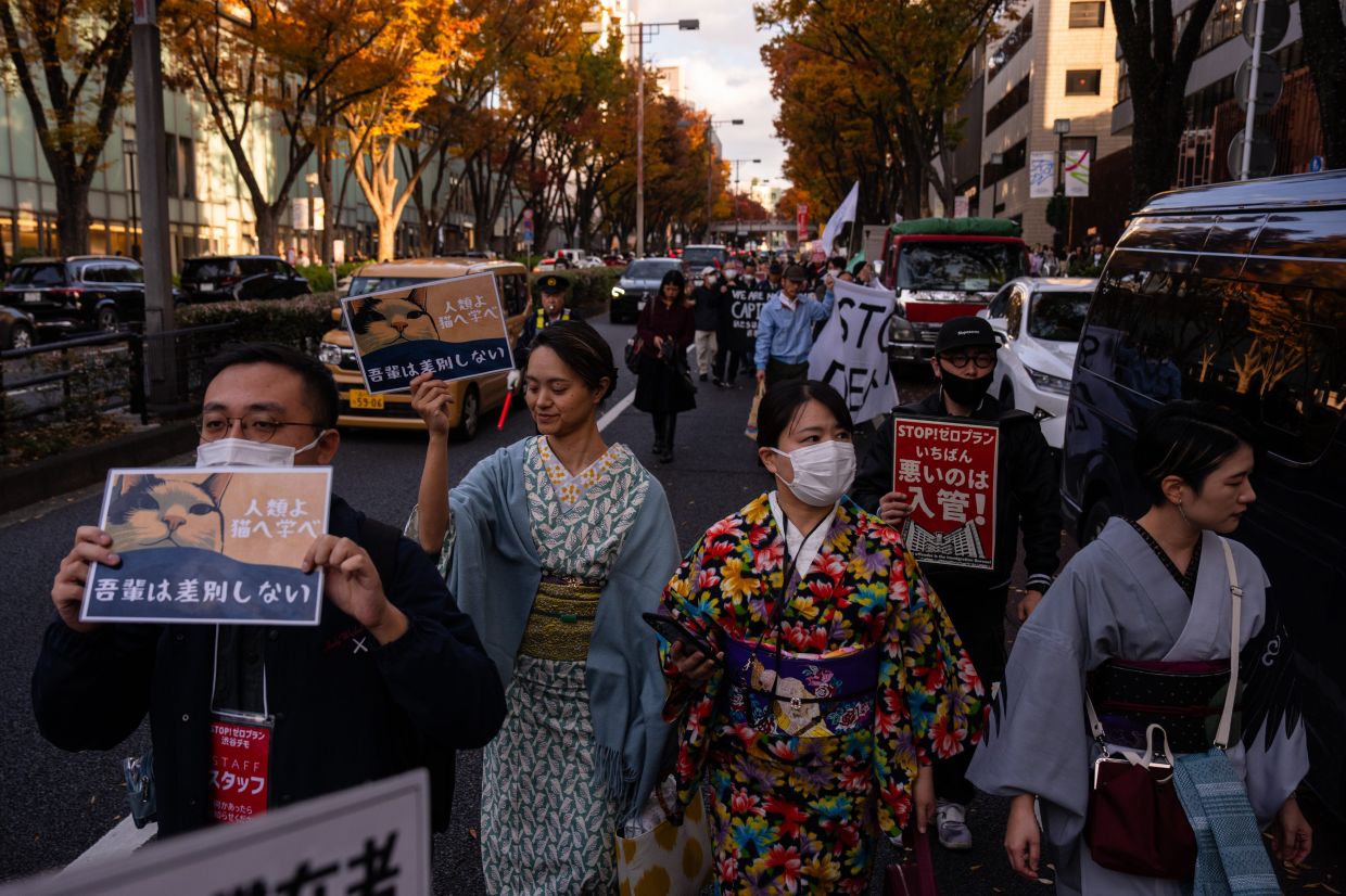 Demonstrators take part in a protest against anti-immigrant policies, in Tokyo, Sunday, Nov 16, 2025. -- AP Photo/Louise Delmotte