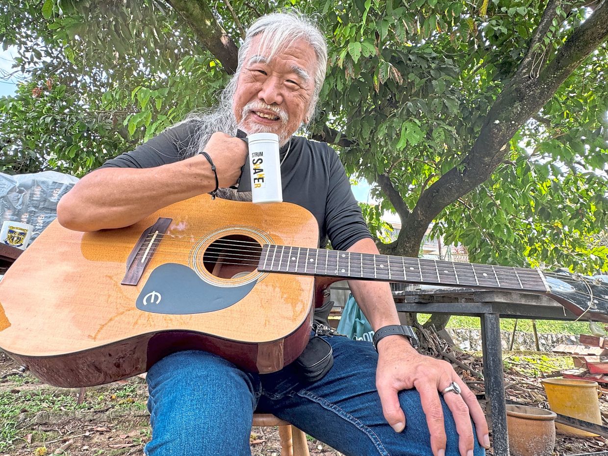Lim showing the ‘Strum Shaker’, a maracas-like device that can be strapped to the hand.