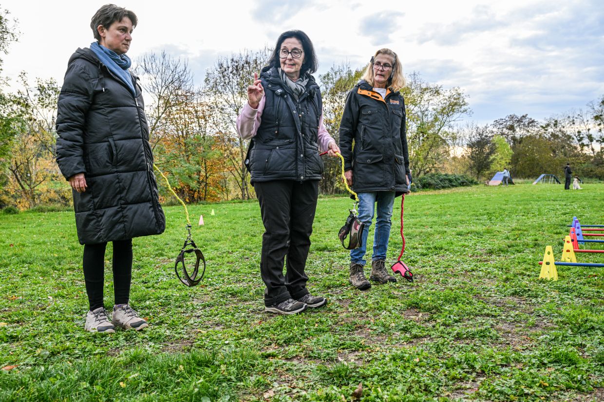 Dog trainer Barbara Gerlinger holds a dog leash and explains hobby dogging to course participants. Photo: Jason Tschepljakow/dpa