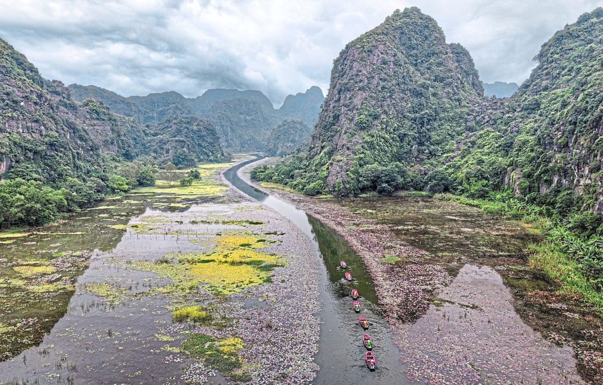 A quiet river cuts through Vietnam’s karst landscape, forming natural curves and patterns that only become clear from the sky.