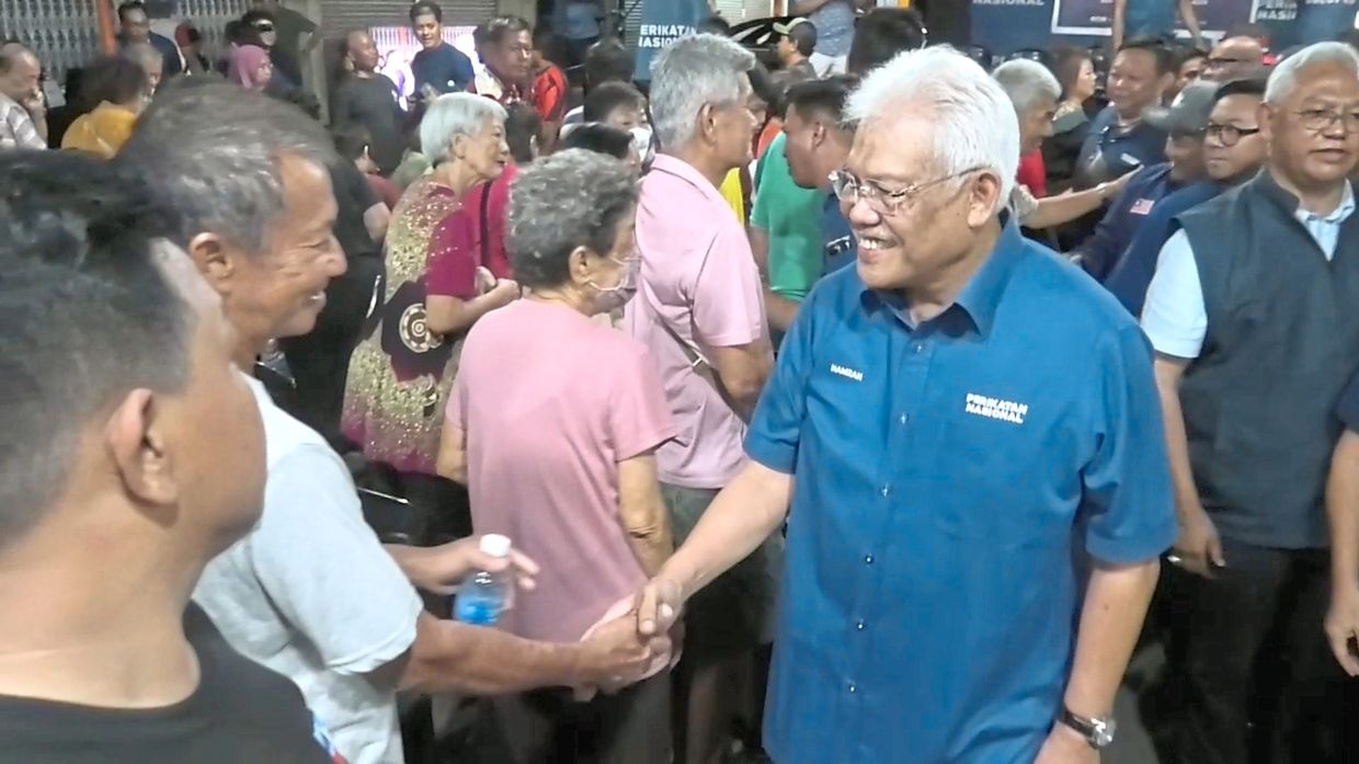 On the ground: Hamzah greeting residents after the Perikatan gathering in Taman Mawar, Sandakan.