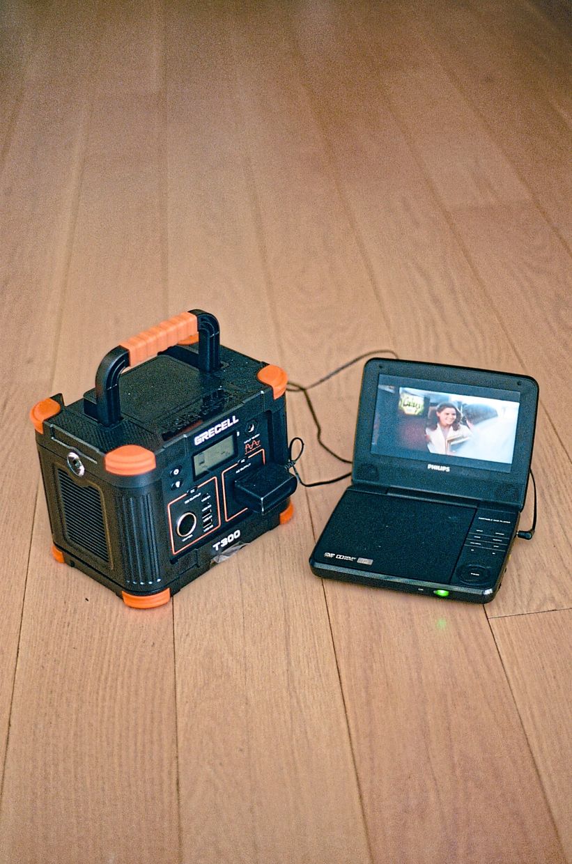 A portable solar generator powering a DVD player used by the author. — Amir Hamja/The New York Times