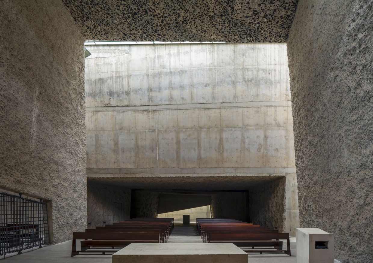 Inspired by the surrounding volcanic landscape, the architecture of The Holy Redeemer Church of Las Chumberas is defined by massive, rough forms that intentionally contrast with the existing built environment. Photo: Roland Halbe