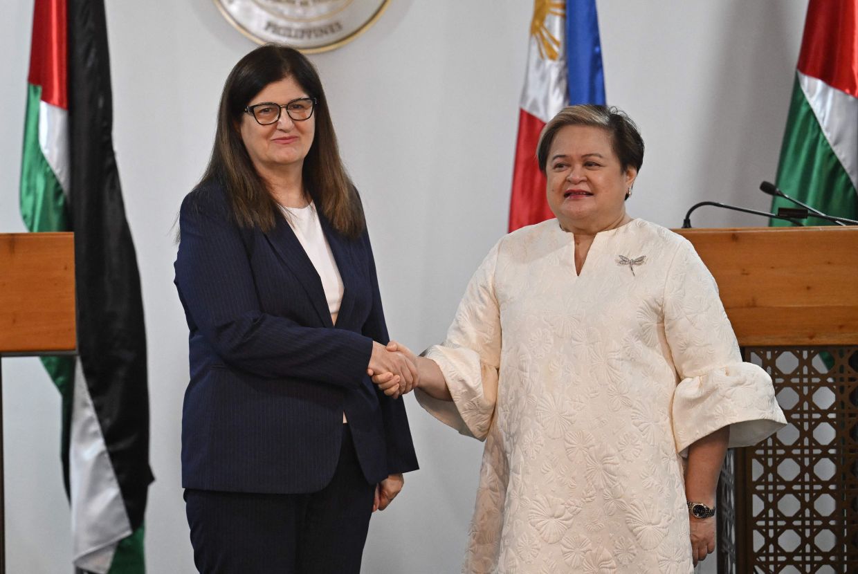 Philippines' Secretary of Department of Foreign Affairs Theresa Lazaro (right) greeting Palestinian Foreign Affairs and Expatriates Minister Varsen Aghabekian Shahin after their joint press conference in Manila on Nov 18, 2025. - AFP