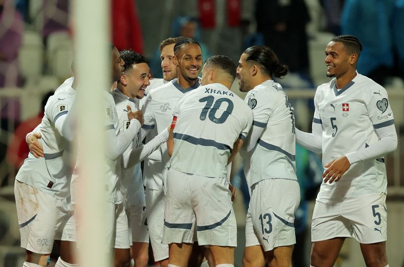 Soccer-Switzerland seal World Cup place despite Kosovo fightback