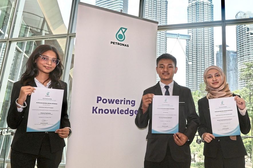 (From left) Jessmietraa, Tan and Aida showing their education sponsorship award certificates after the award presentation ceremony at KLCC. — Photos by LOW BOON TAT/The Star