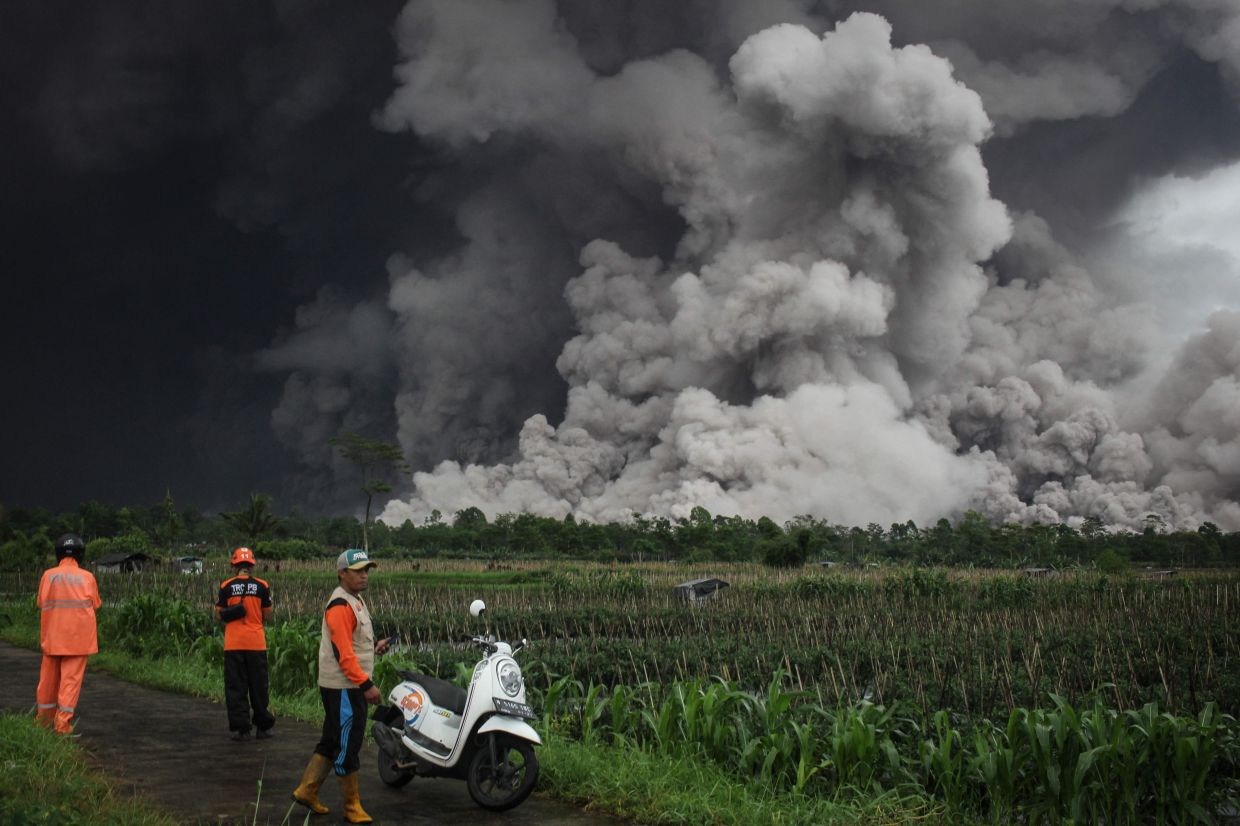 People looking at a pyroclastic flow during the eruption of Mount Semeru in Lumajang, East Java, on Nov 19, 2025. - AFP