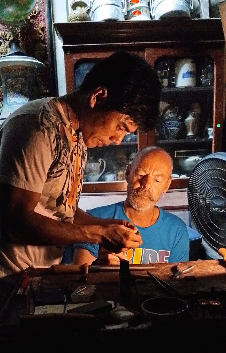 Luar (left) guiding a customer through the process of crafting a handmade ring.