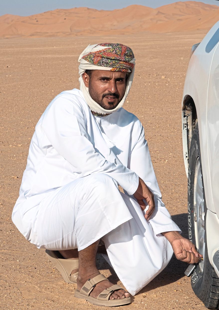 Mohammed Mussallem lets out air in his car’s tyres, as that helps a vehicle travel over the endless amounts of sand.