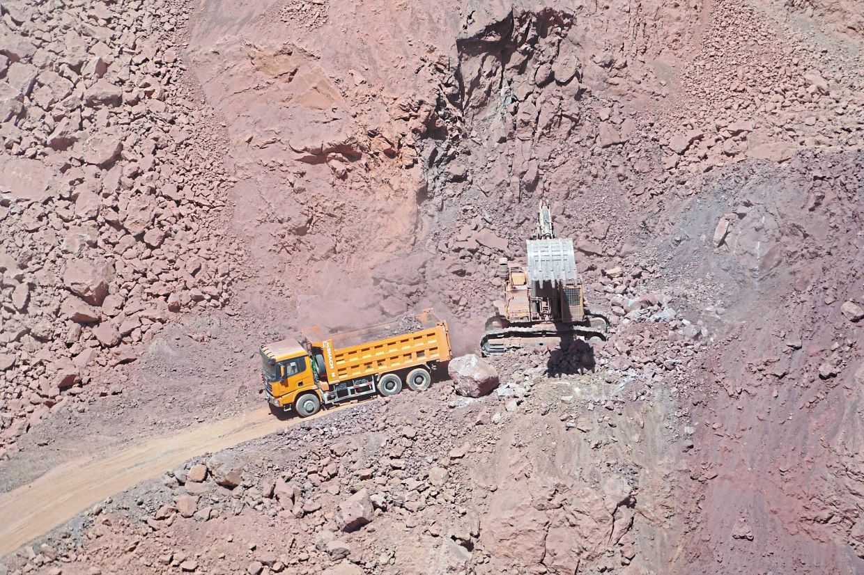 Workers of Talco Gold, the joint Tajik-Chinese mining firm, extracting antimony in open cast quarries at the Saritag mine in western Tajikistan. — AFP