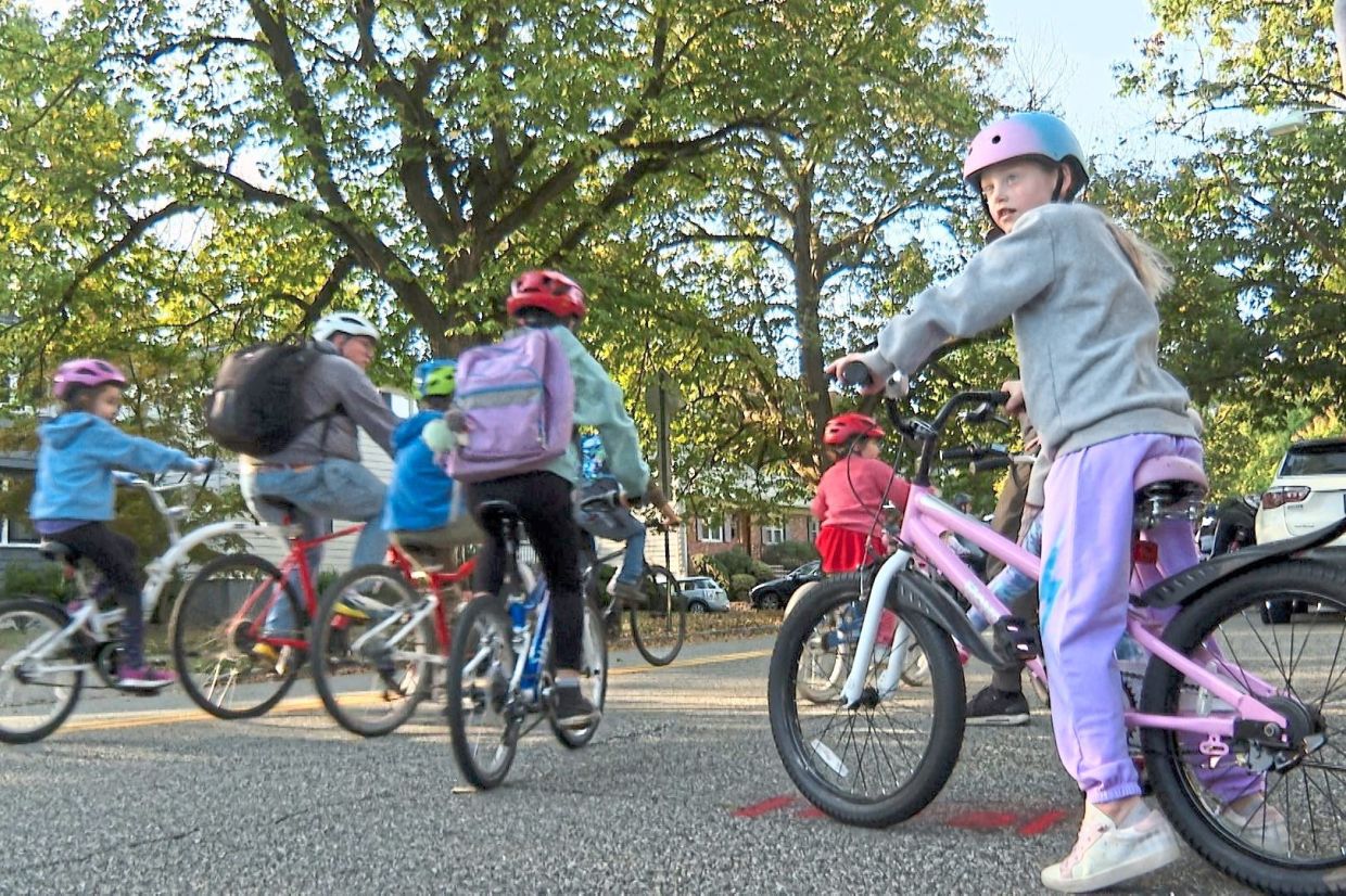 Children ride their bicycles to school during the ‘bike bus’ ride. Photo: AP