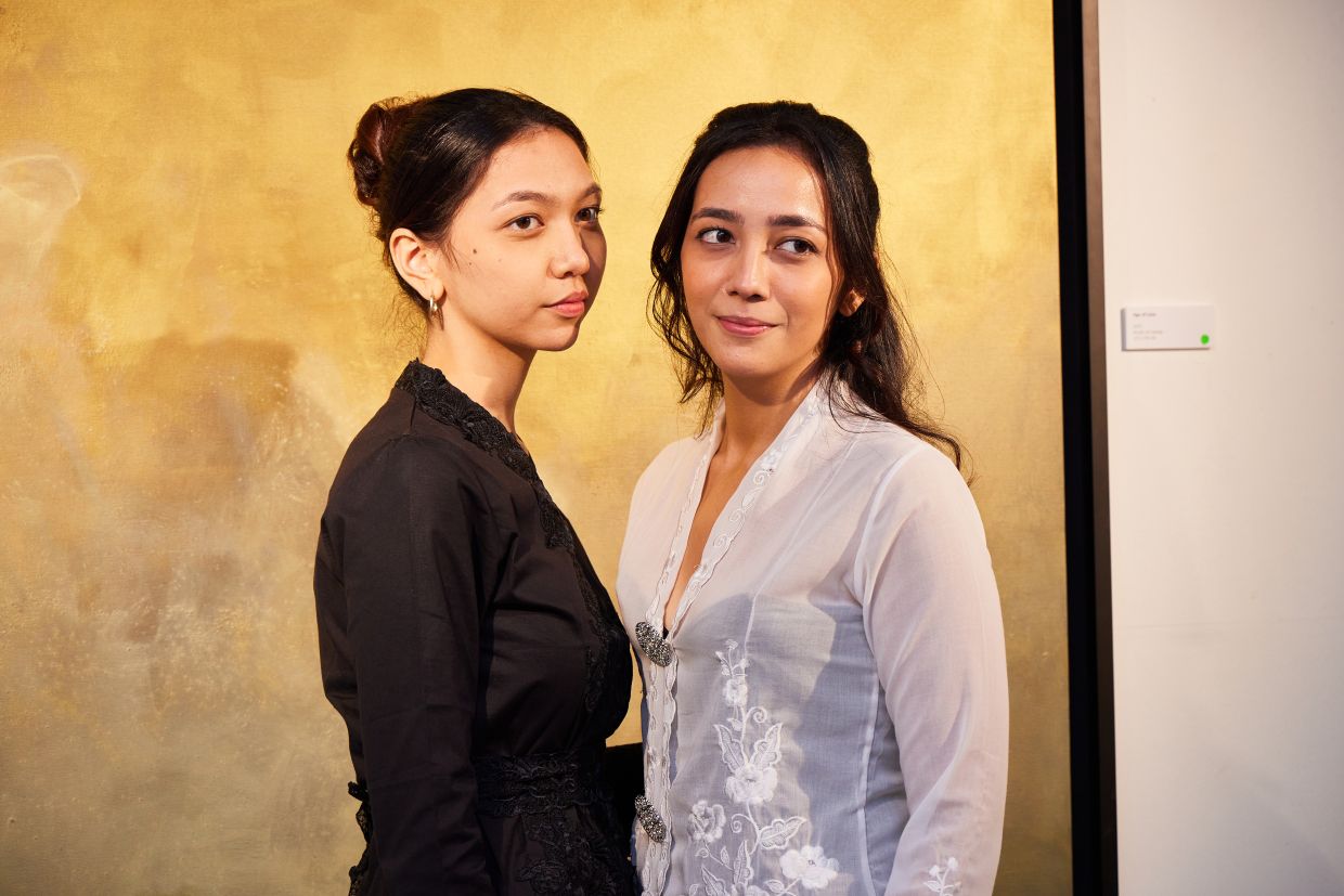 Sisters Zahara (left) and Mulaika pose during the opening of 'I Remember You' at Harta Space in Selangor. Photo: Harta Space