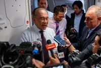 Anwar discusses policies, transparency in media session on Johannesburg flight