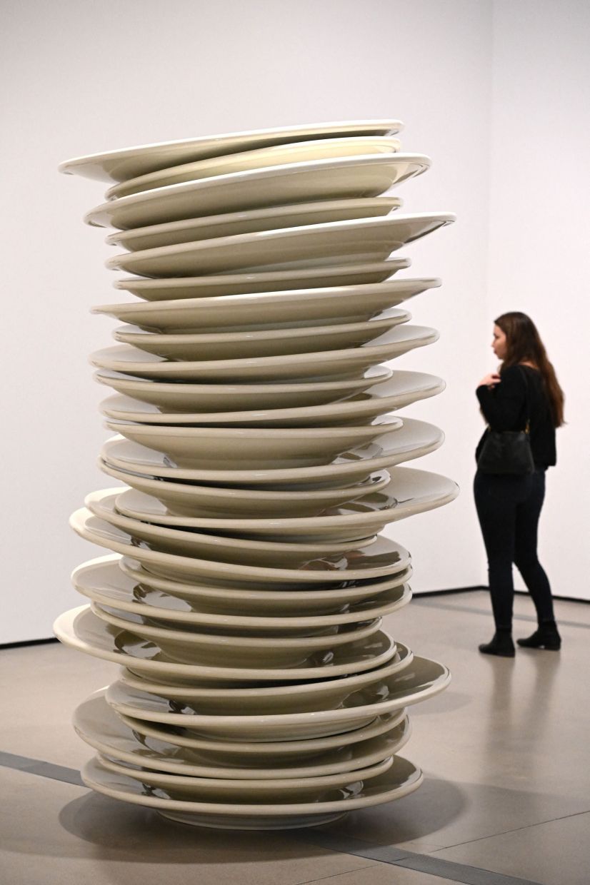 A visitor looks at 'No Title (stacked plates, white)', a 1993 large-scale work by Therrien. Photo: AFP 