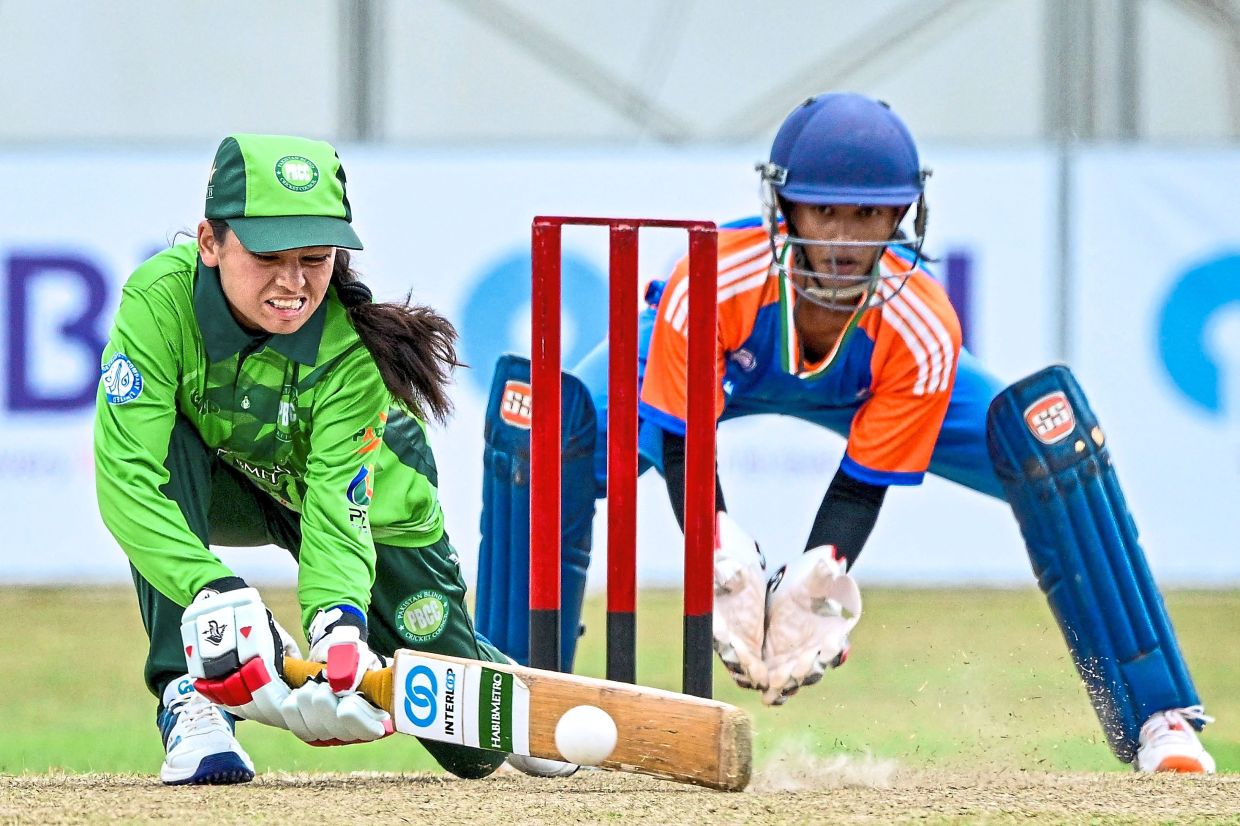 Pakistan's Mehreen Ali (left) plays a shot during the match.