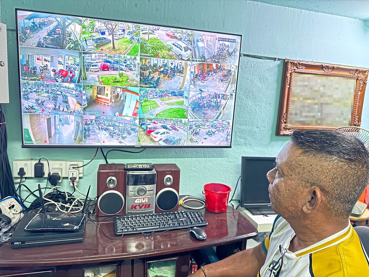 Ismail monitoring traffic and parking via a CCTV system at PPR Kampung Muhibbah.