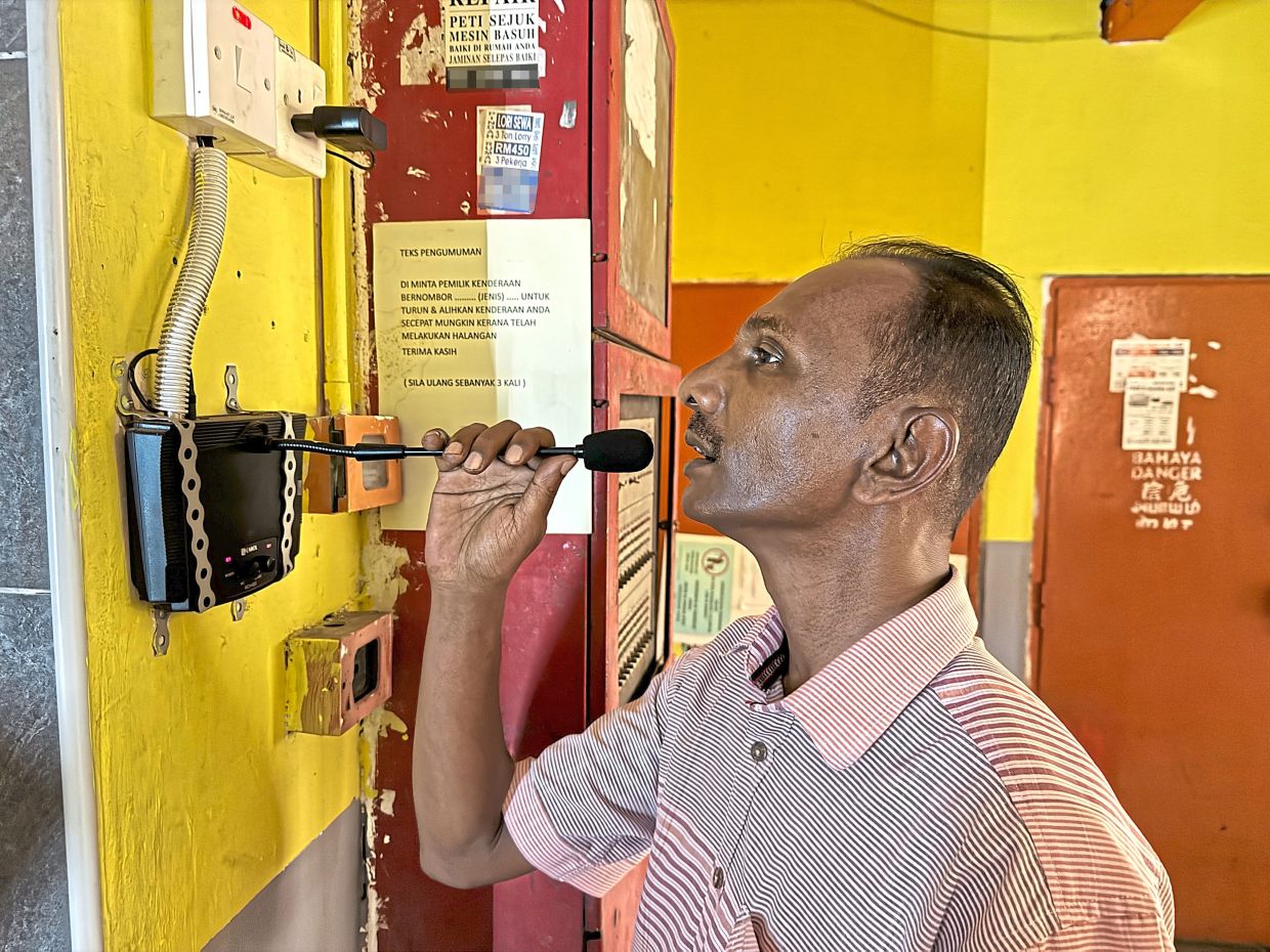 Atar using a PA system to alert vehicle owners to move their cars at PPR Kampung Muhibbah.