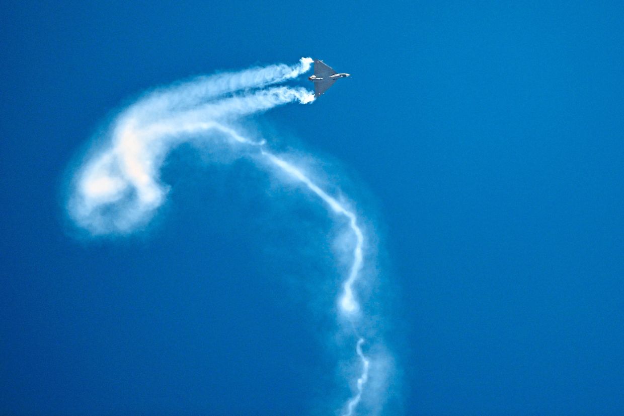 The jet which crashed the following day performing a flying display at Al-Maktoum International Airport, Dubai. The jet was executing a manoeuvre when it plunged to the ground and erupted into a fireball. — Reuters/AFP 