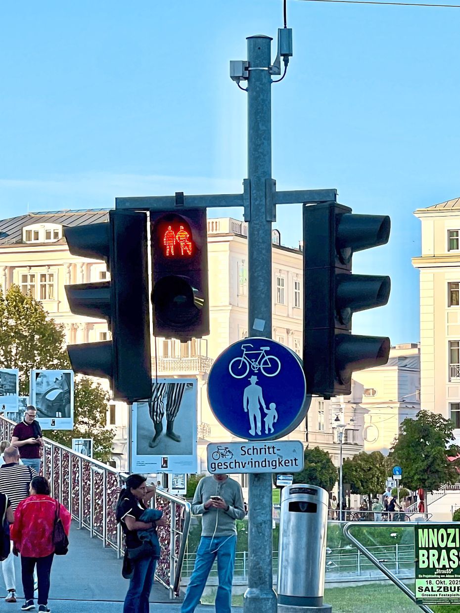 By the Makartsteg Love Lock Bridge, Salzburg’s signboards and traffic lights reflect inclusivity.