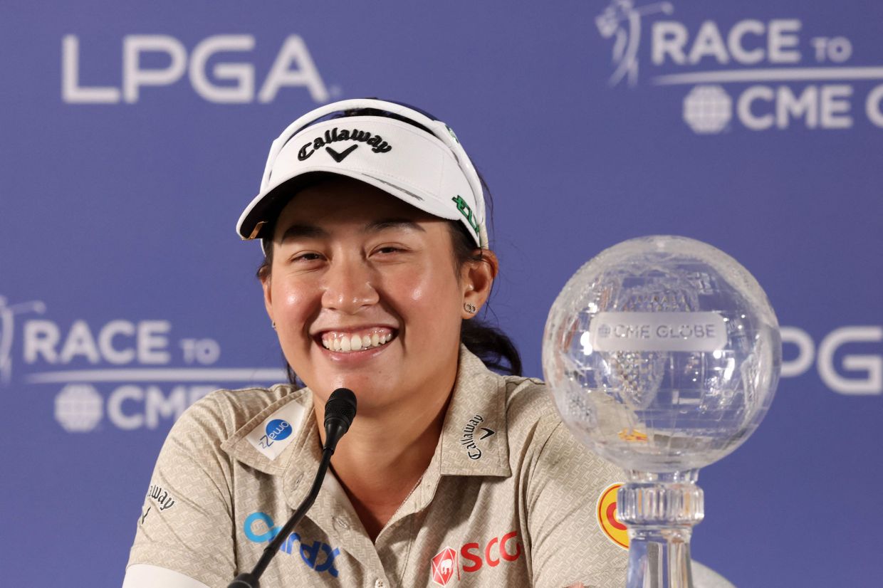 Jeeno Thitikul of Thailand with the CME Group trophy as she speaks to the media after her win during the final round of the CME Group Tour Championship 2025 at Tiburon Golf Club on November 23, 2025, in Naples, Florida.- Photo by Michael Reaves / Getty Images via AFP)