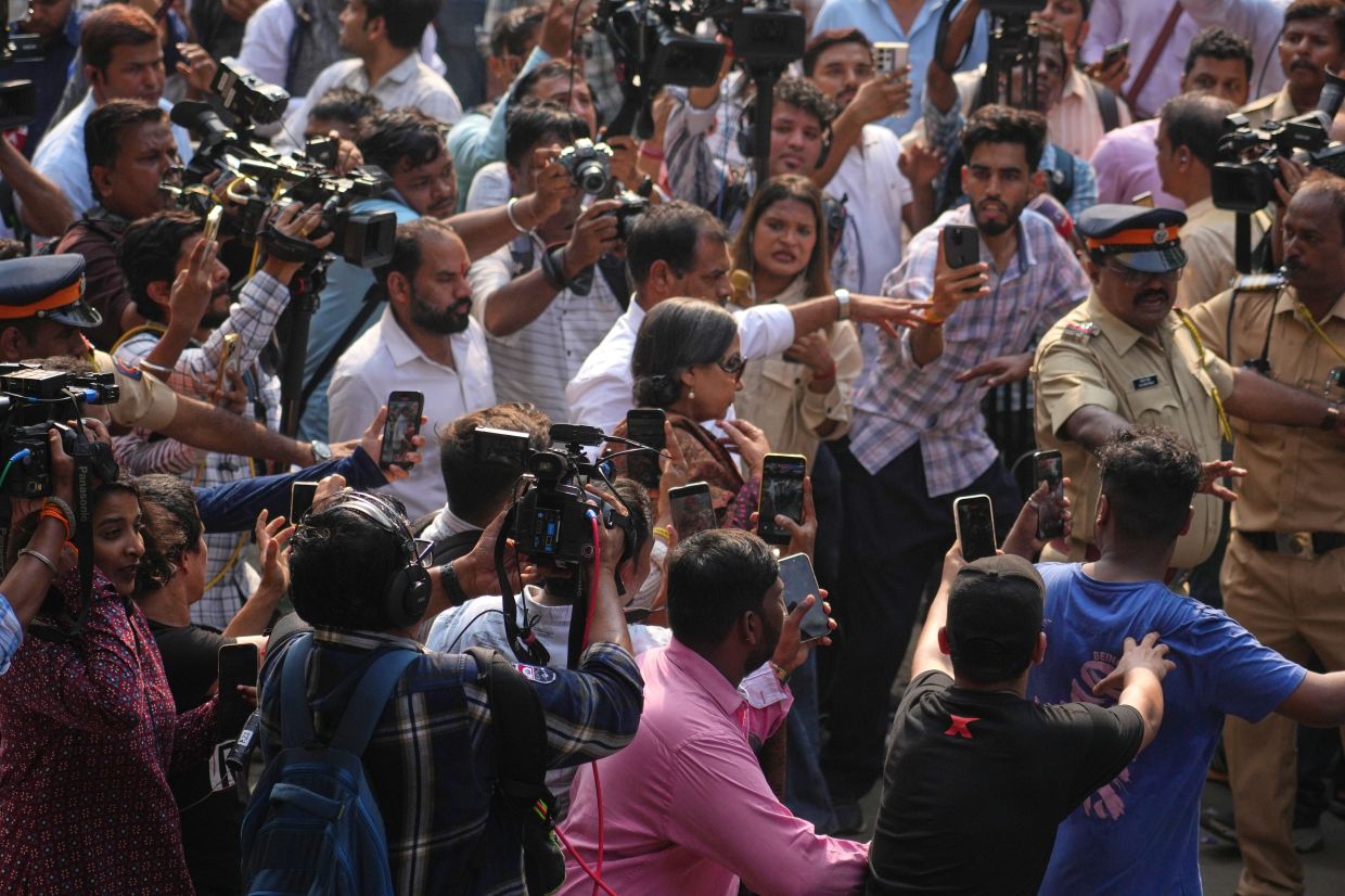 Bollywood actor Shabana Azmi, center, arrives at a cremation center to pay homage to Bollywood actor Dharmendra who died Monday, in Mumbai India, Monday, Nov. 24, 2025. -- AP Photo/Rafiq Maqbool