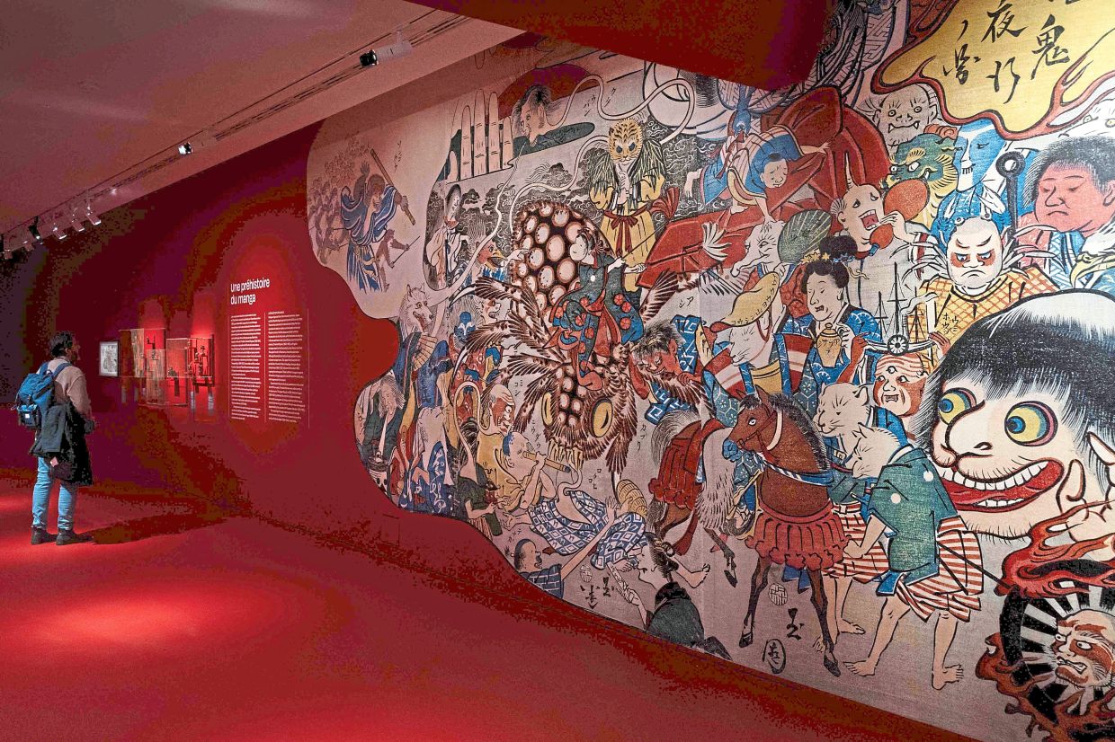 A visitor reads the exhibition notes at the entrance of the Guimet Museum. Photo: AFP 