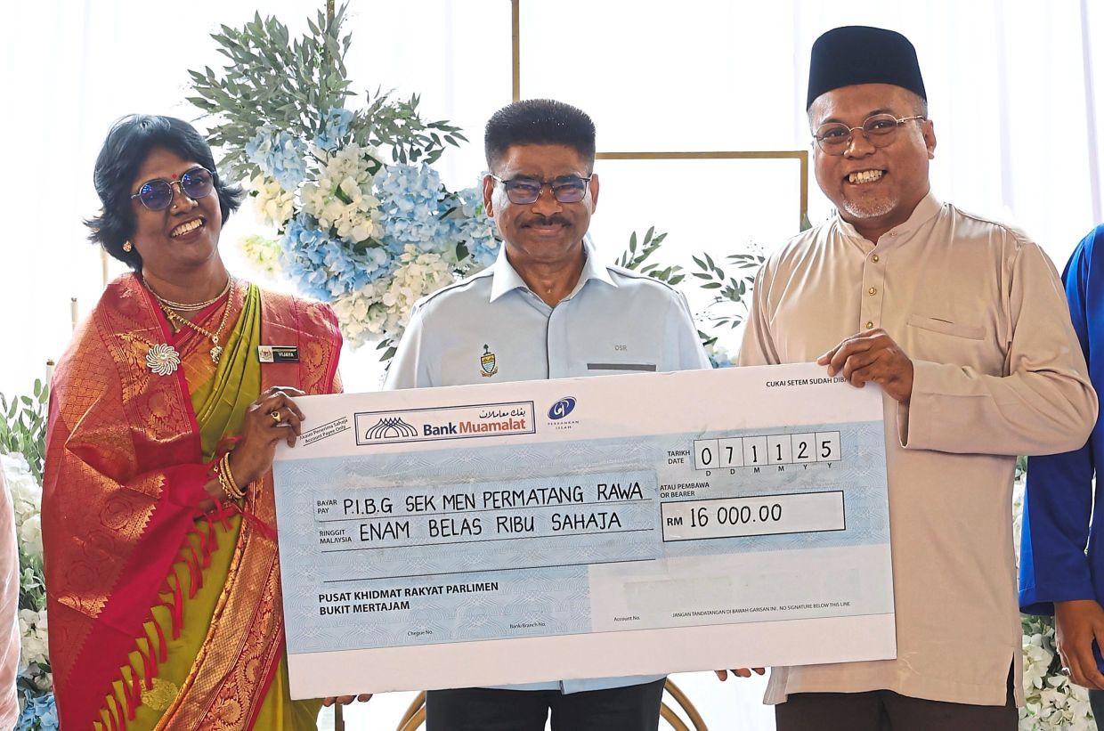 JKP Sdn Bhd chief executive officer Farizul Arif Abd Mutalib (right) handing over the RM16,000 contribution to Vijayaletchumi (left) on behalf of Sim’s office. With them is Sundarajoo.