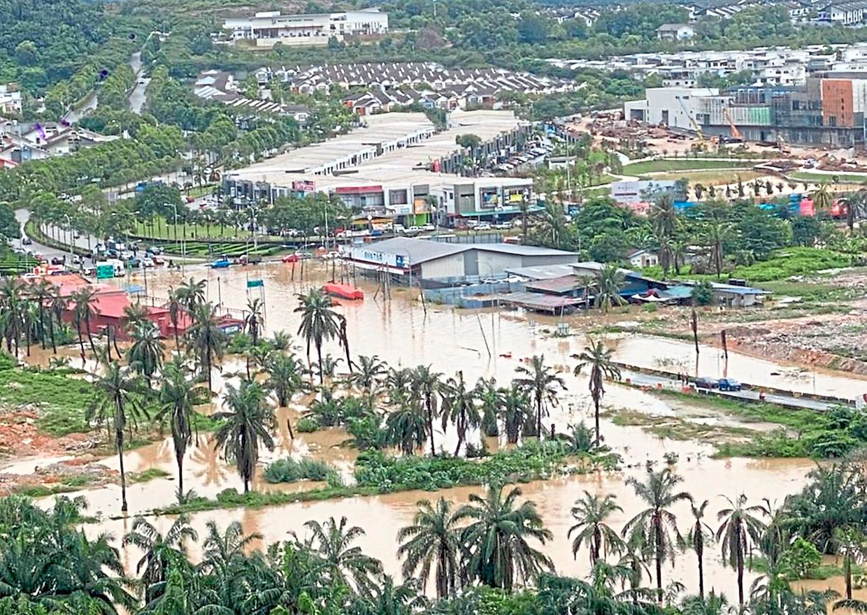 Inundated: The roads and bridge to Puncak Alam are cut off by floodwaters after heavy rain.