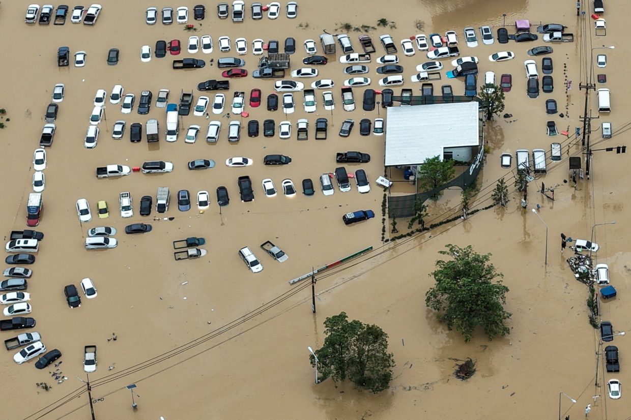 A drone view showing cars parked in a flooded area in Hatyai district. - Reuters