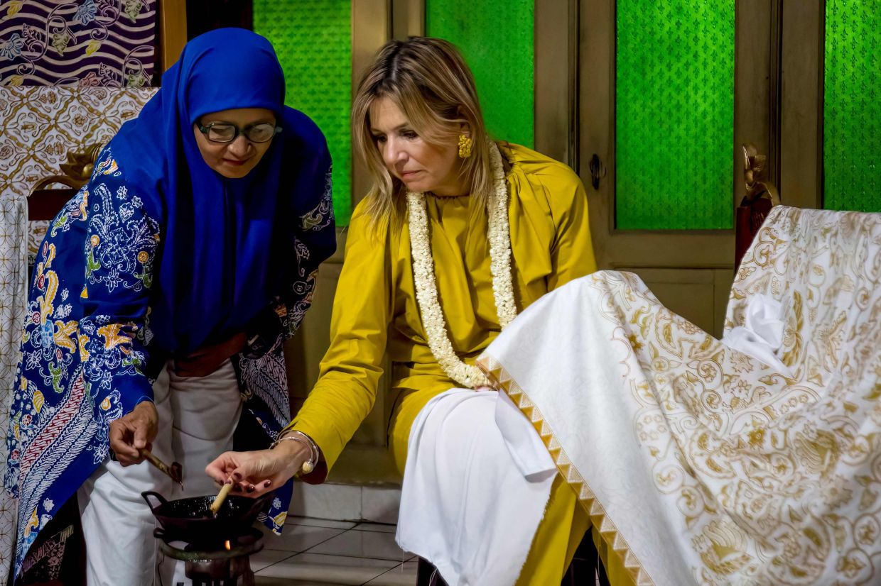Queen Maxima of the Netherlands, in her capacity as the UN Secretary-General's Special Advocate for Inclusive Finance for Developmen, triying her hand at making batik at the Laweyan Batik Village in Surakarta, Central Java, on Nov 25, 2025. - AFP