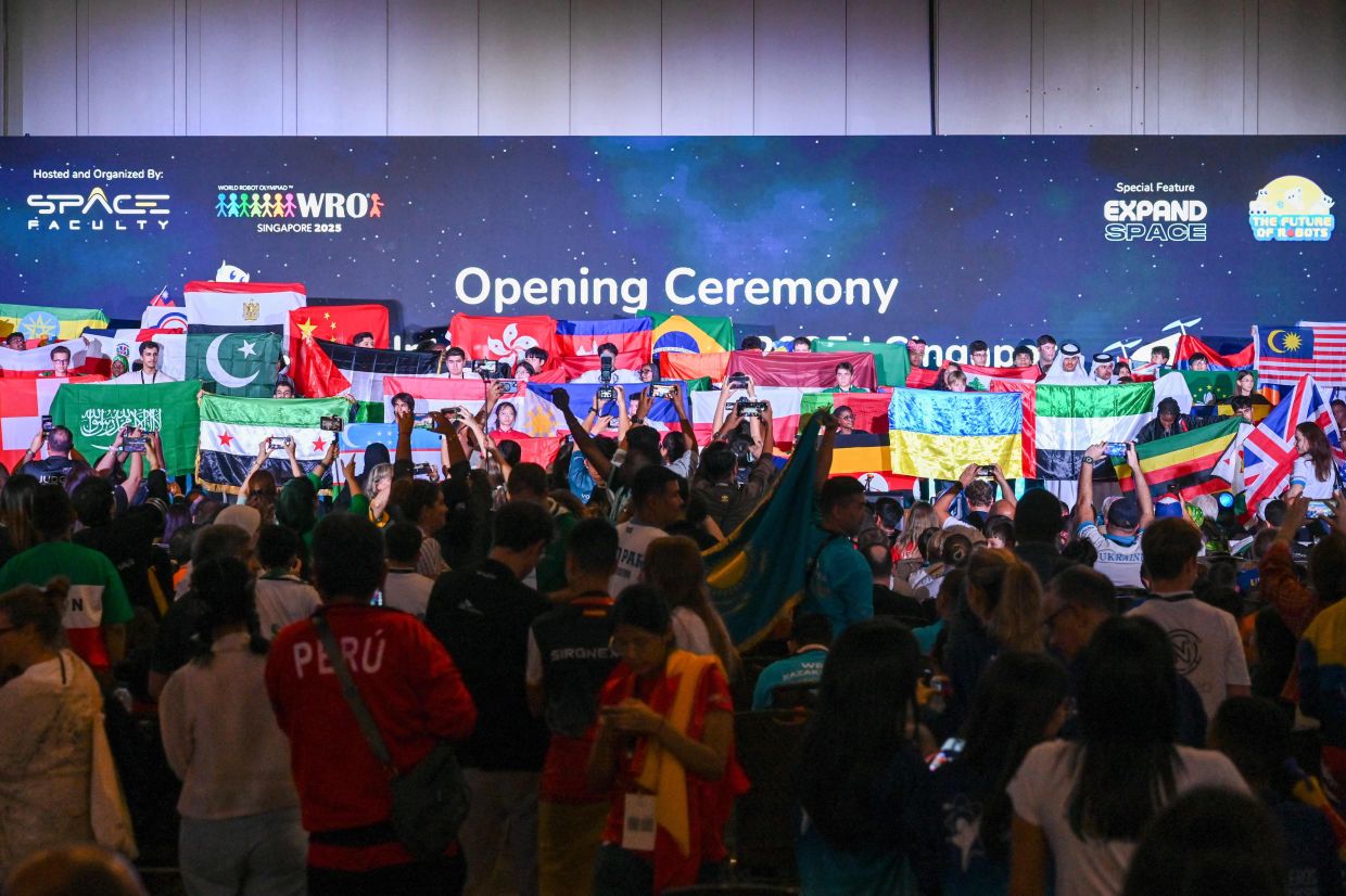 Participants from more than 90 countries attend the opening ceremony of the World Robot Olympiad competition in Singapore on Wednesday, November 26, 2025. -- Photo by Roslan RAHMAN / AFP