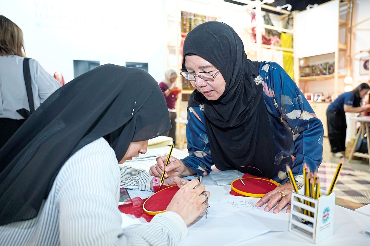 'With only a few crafters left, keringkam is a heritage art that needs the younger generation to keep it alive,' says Ros (right).