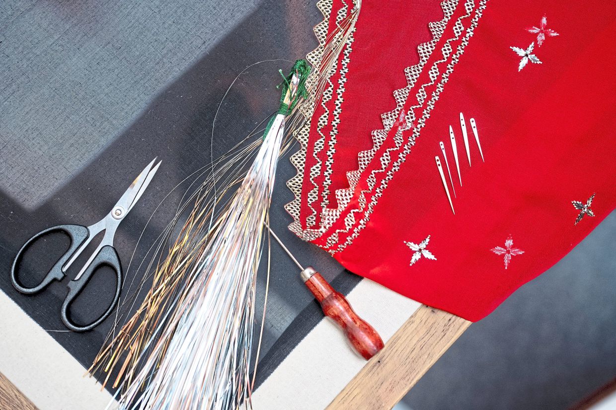 One shawl with keringkam embroidery can take months to make, using threads worth hundreds of ringgit. Photo: Yayasan Hassanah