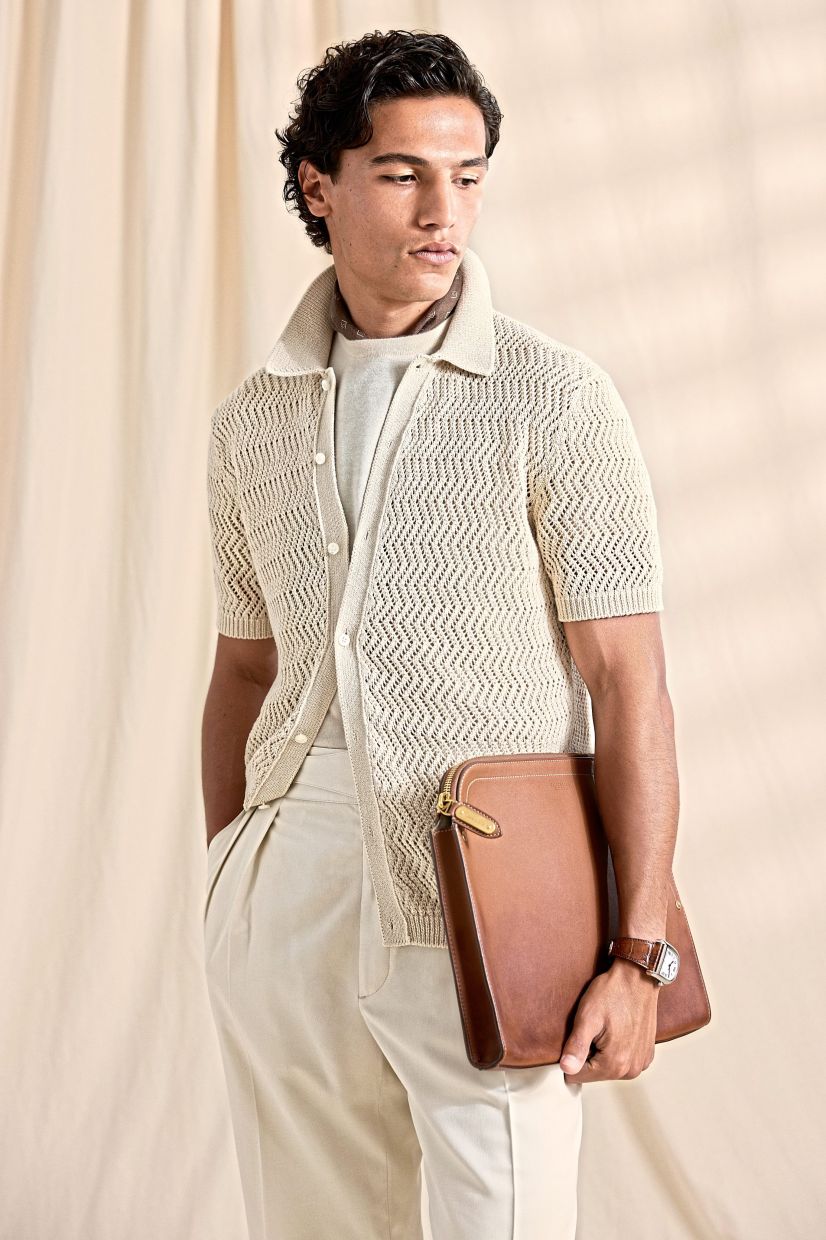 Tailored trousers and T-shirt, styled with a knit top and tan accessories create a campus-cool vibe. Photo: Ralph Lauren