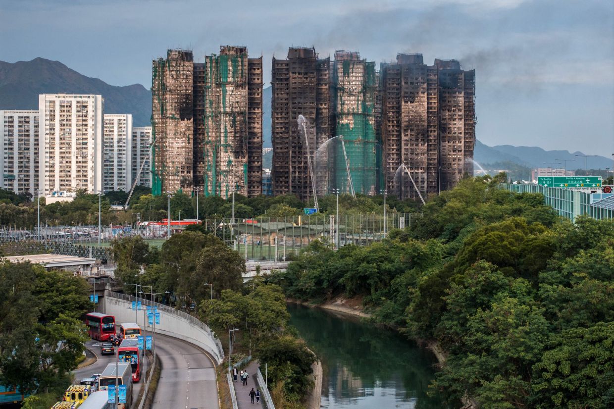 Smoke rising from apartments on Nov 27 after a major fire swept through several blocks at the Wang Fuk Court residential estate in Hong Kong's Tai Po district on Nov 26. Hong Kong authorities said on Nov 27 the death toll from the city's worst fire in decades had risen to 65, with 250 people still listed as missing. - AFP