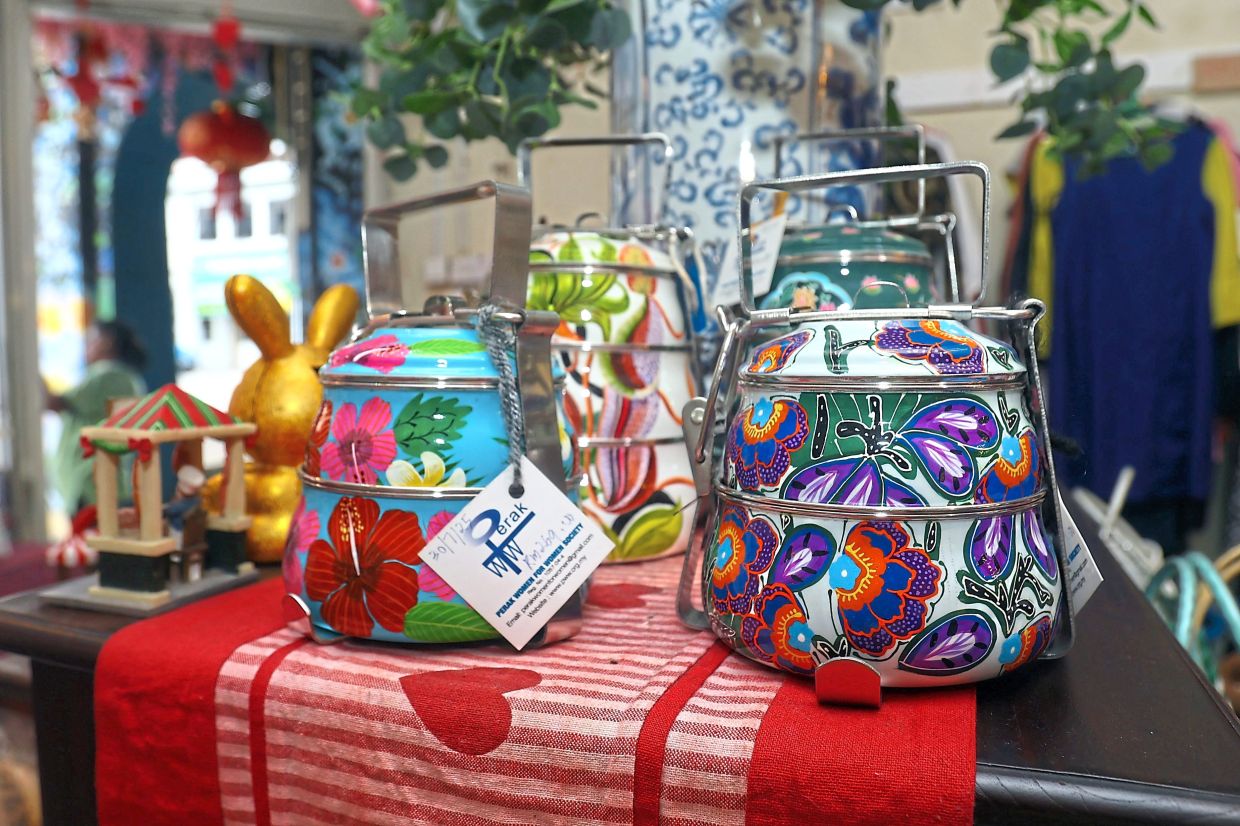 Beautiful hand-painted tiffin carriers sold at the PWW shop in Ipoh.