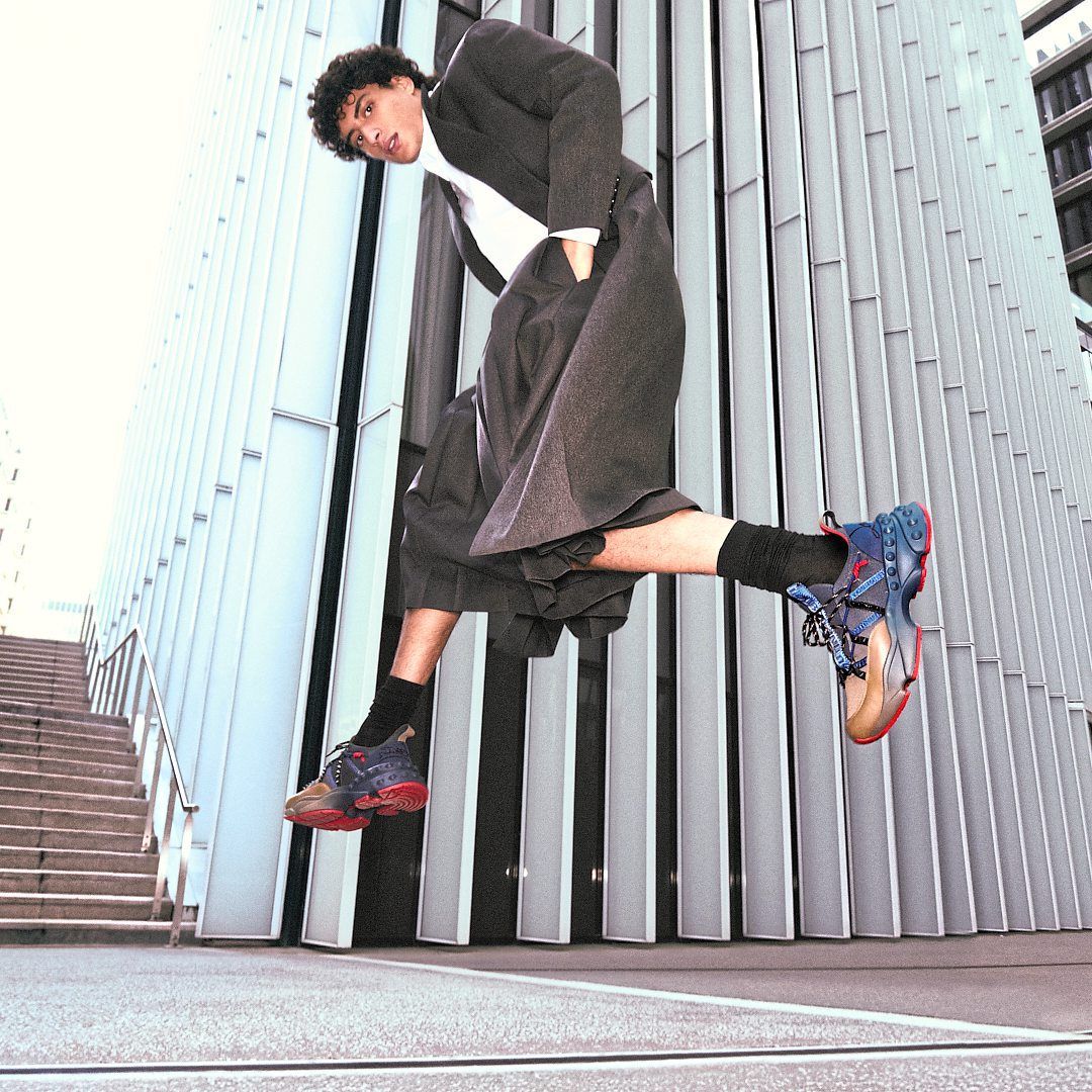 Inspired by hiking boots, the Trailnrun running sneaker features a heel tab and signature Gun Metal grey spikes. Photo: Christian Louboutin