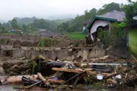 Indonesian town buries its dead in mass grave as flood toll rises