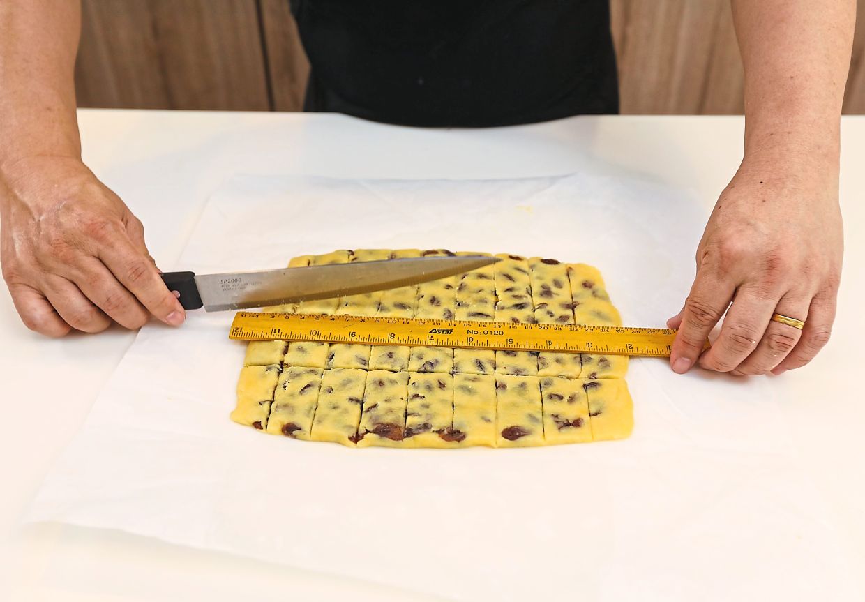 Spread a layer of raisins over one rectangle, overlay with the other rectangle, then chill and roll again into a larger rectangle. Cut into bars and prick with a fork.