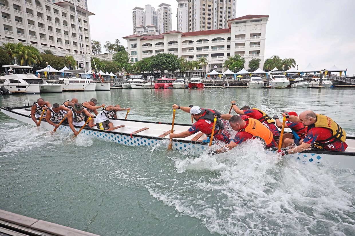 Participants showing how the dragon boat tug-of-war is done at Straits Quay Marina, Penang. — CHAN BOON KAI/The Star 