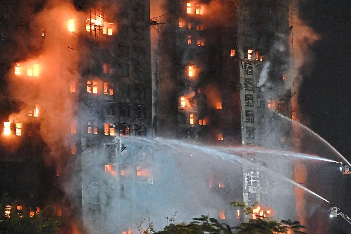 Firefighters trying to put out the fire at the Wang Fuk Court residential estate.