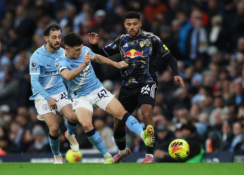 Soccer-Foden's double secures Manchester City's thrilling win over Leeds