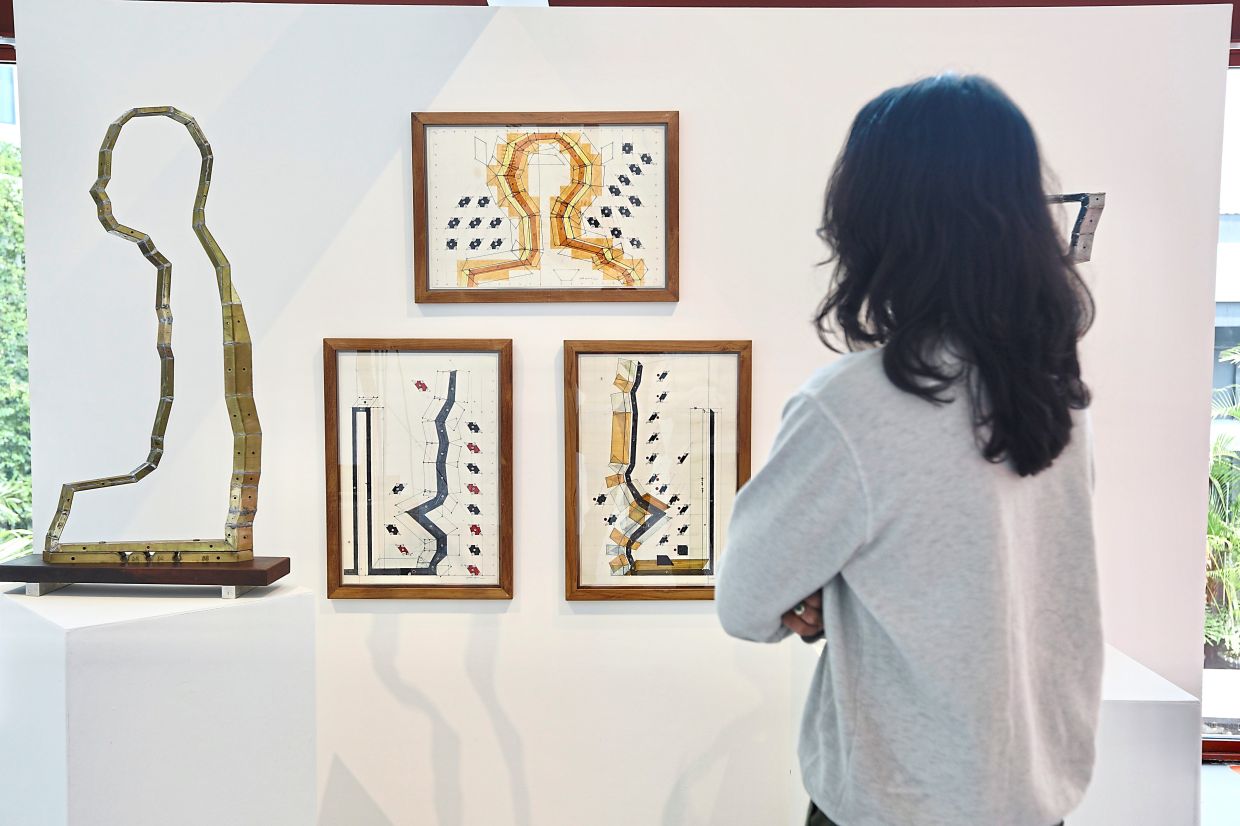 Visitor views Thai artist Tawatchai Puntusawasdi’s works at Tali Art Gallery. Photo: The Star/Low Lay Phon