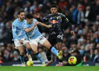 Soccer-Foden double helps Manchester City secure thrilling win over Leeds