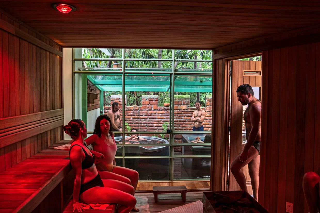 People sit in the sauna at Koti Wellness, a contrast therapy spa in Mexico City.