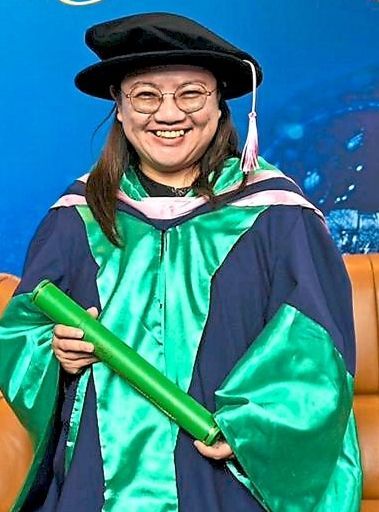 Proud moment: Chin holding her scroll at the convocation ceremony.
